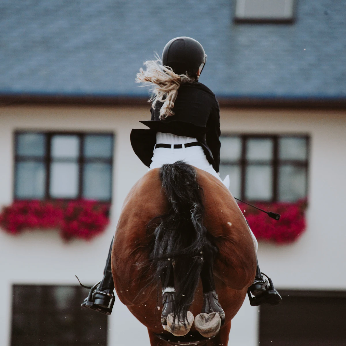 A rider in a tailcoat riding straight towards the camera